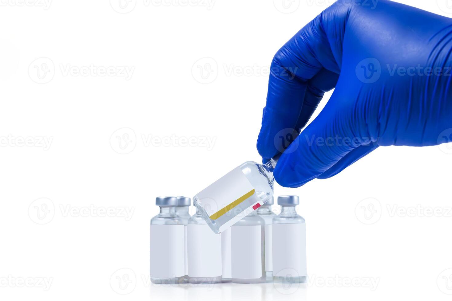 Hand in blue glove holding vaccine vials on white background photo