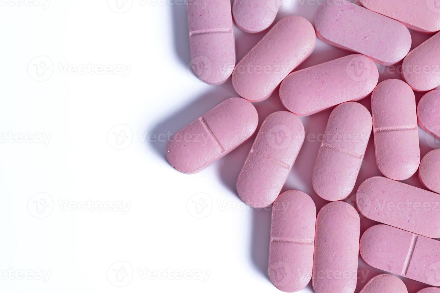 Pink pills isolated on white background with copy space for your text. photo