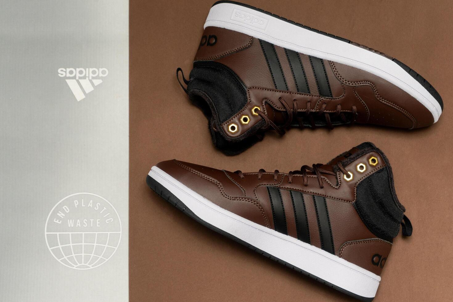 Evora, Portugal. March 3, 2024. Adidas brown boots on a matching brown background, highlighting sleek design and rugged texture. Perfect for outdoor adventures and style. photo