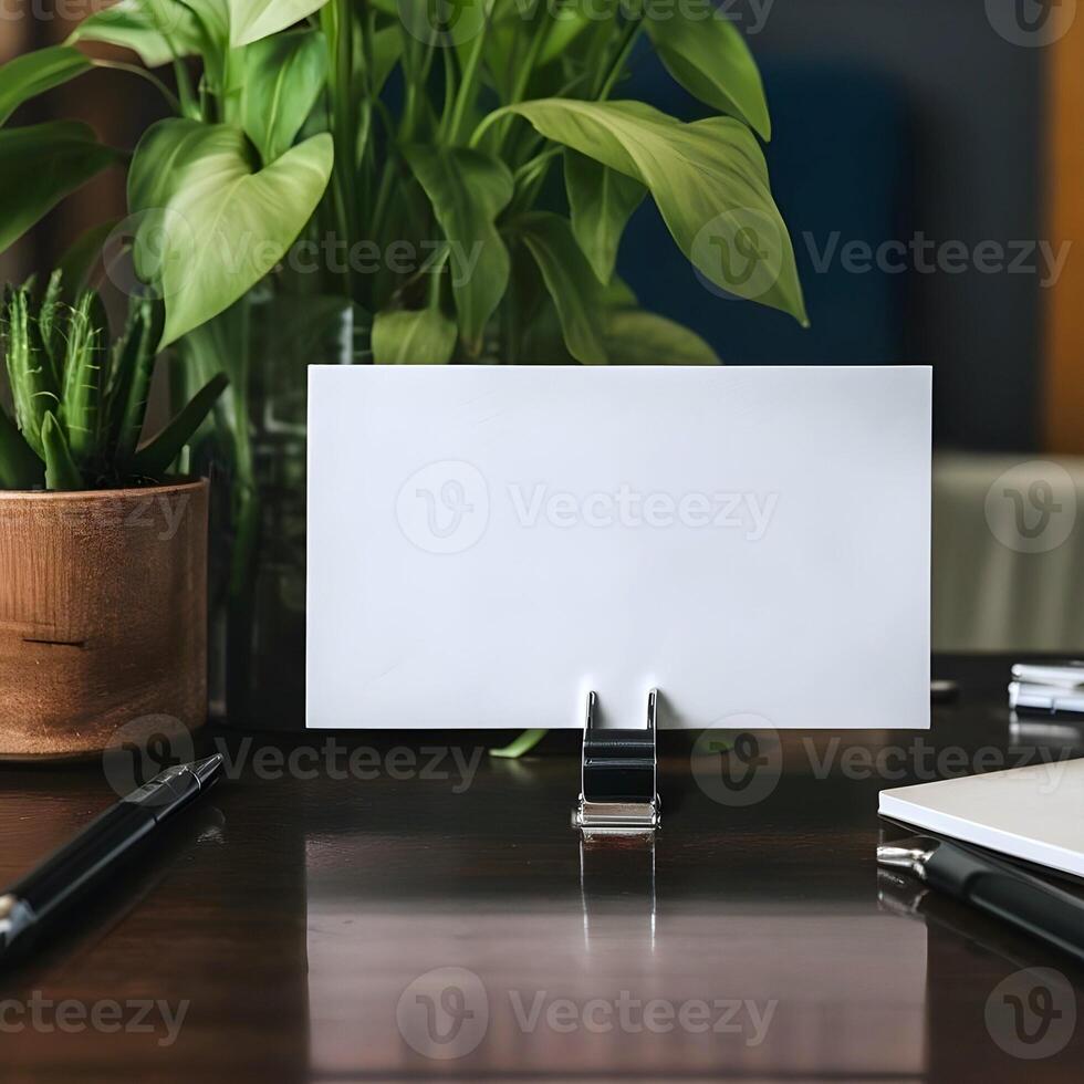 A blank white business card mockup is presented on office desk table photo
