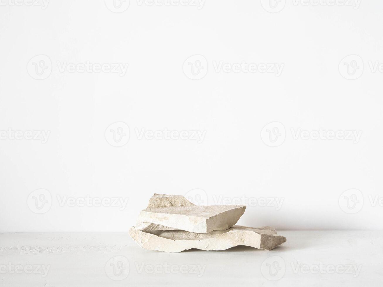 Grey natural stones podium on white background, platform for product display. photo