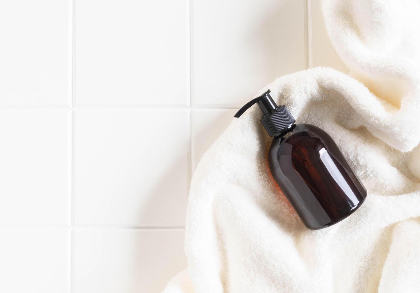Brown bottle mockup for bathing products in bathroom photo