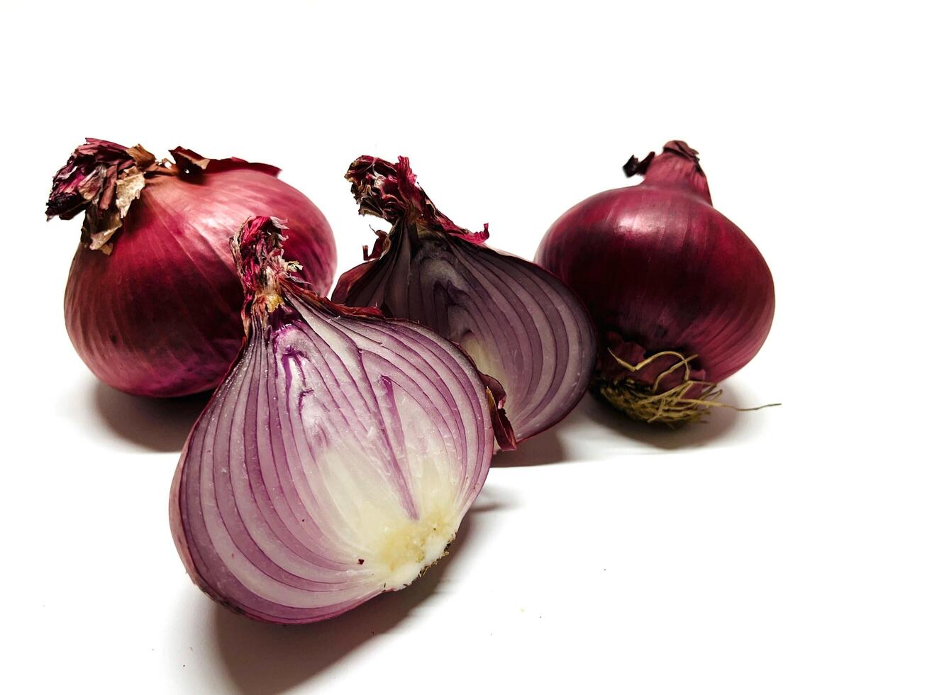 Red whole and sliced onion, isolated on white background. Big red onion photo