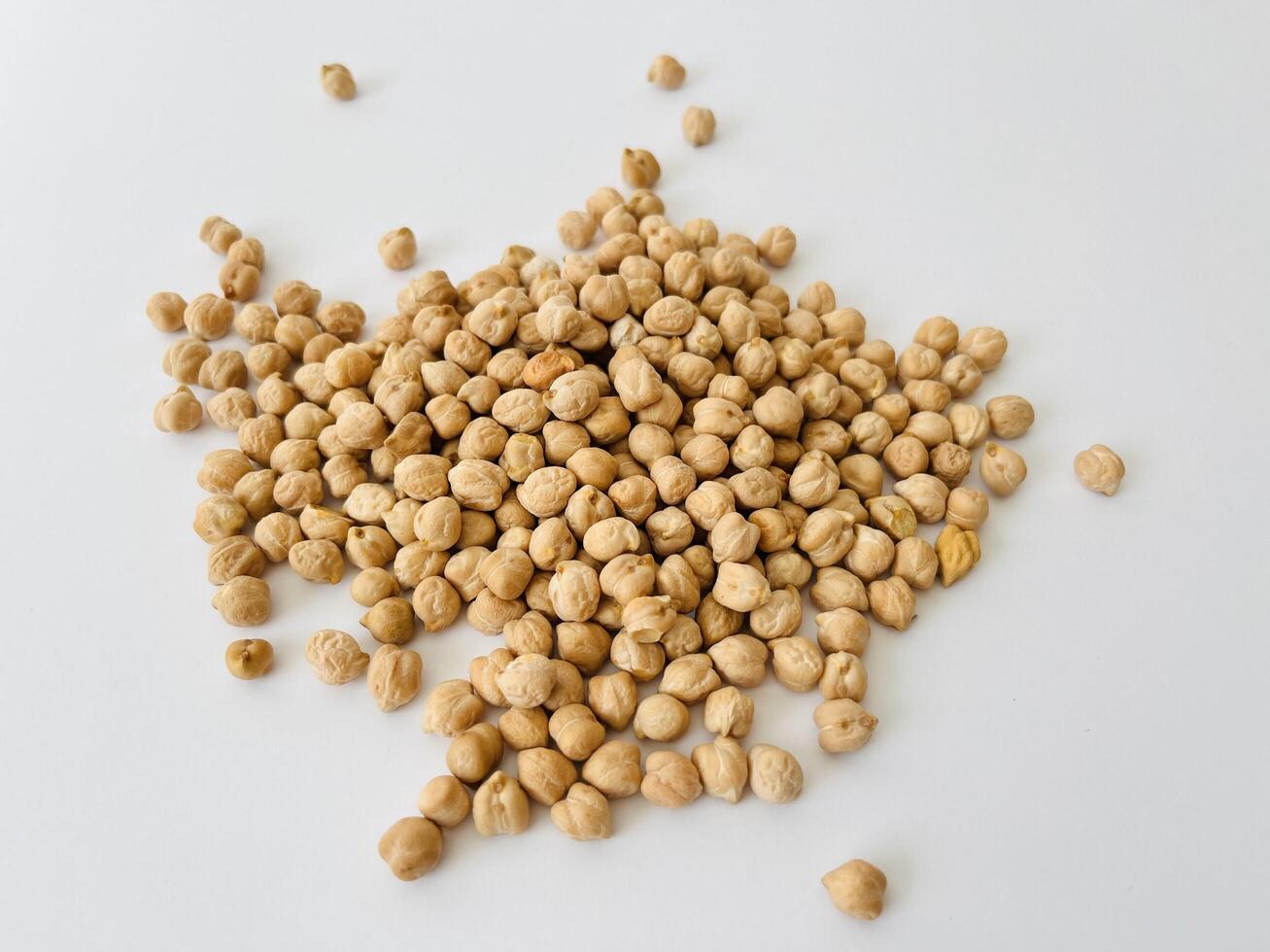 Raw dry chickpea on white background. Traditional ingredient for cooking hummus. Middle Eastern and Mediterranean cuisine. Selected focused photo