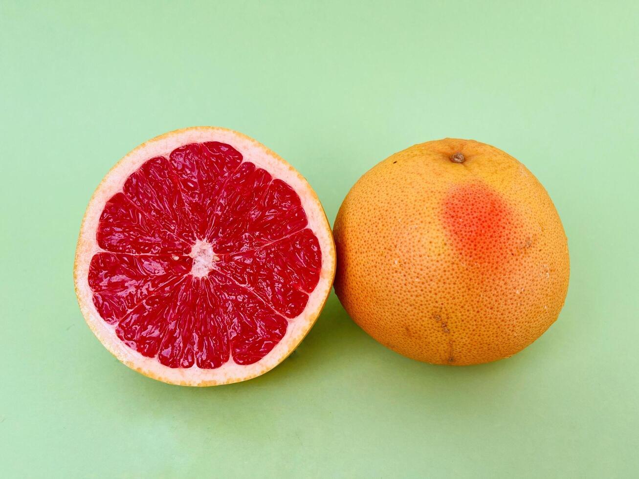 Fresh grapefruit fruit. Grapefruit isolated on green background. Grapefruit with clipping path. photo