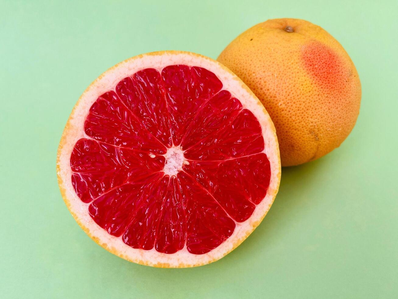 Fresh grapefruit fruit. Grapefruit isolated on green background. Grapefruit with clipping path. photo