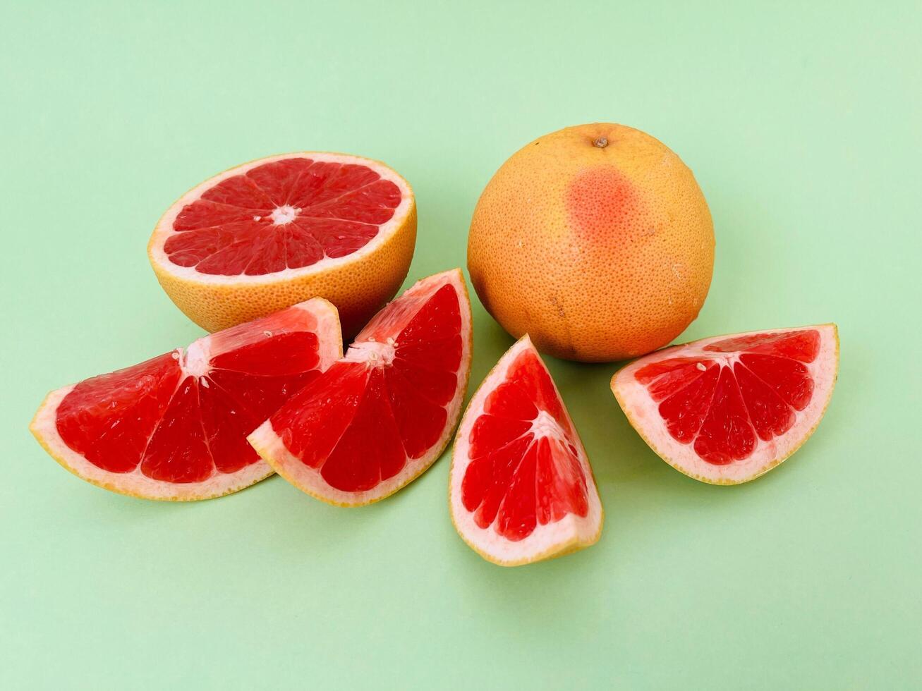 Fresh grapefruit fruit. Grapefruit isolated on green background. Grapefruit with clipping path. photo