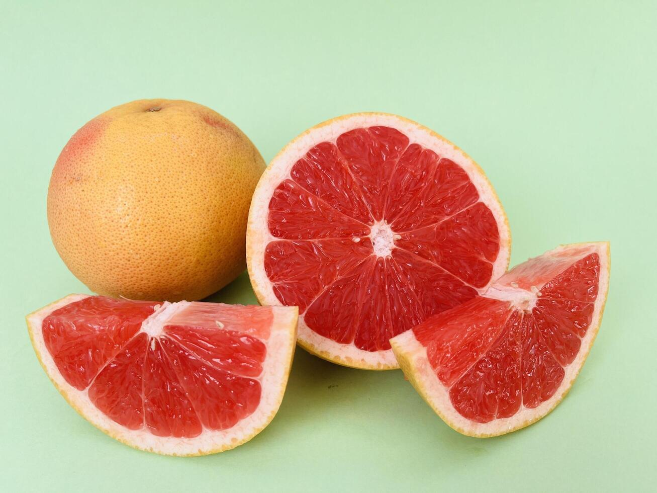 Fresh grapefruit fruit. Grapefruit isolated on green background. Grapefruit with clipping path. photo