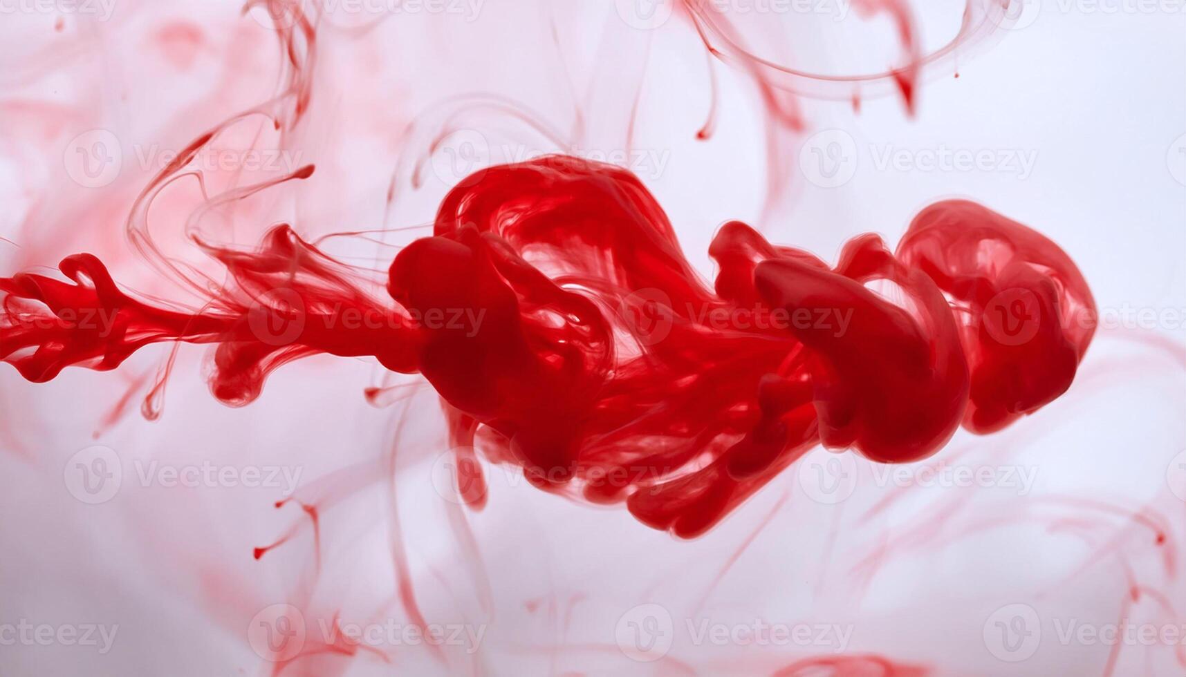 a red liquid is being poured into a heart shape photo