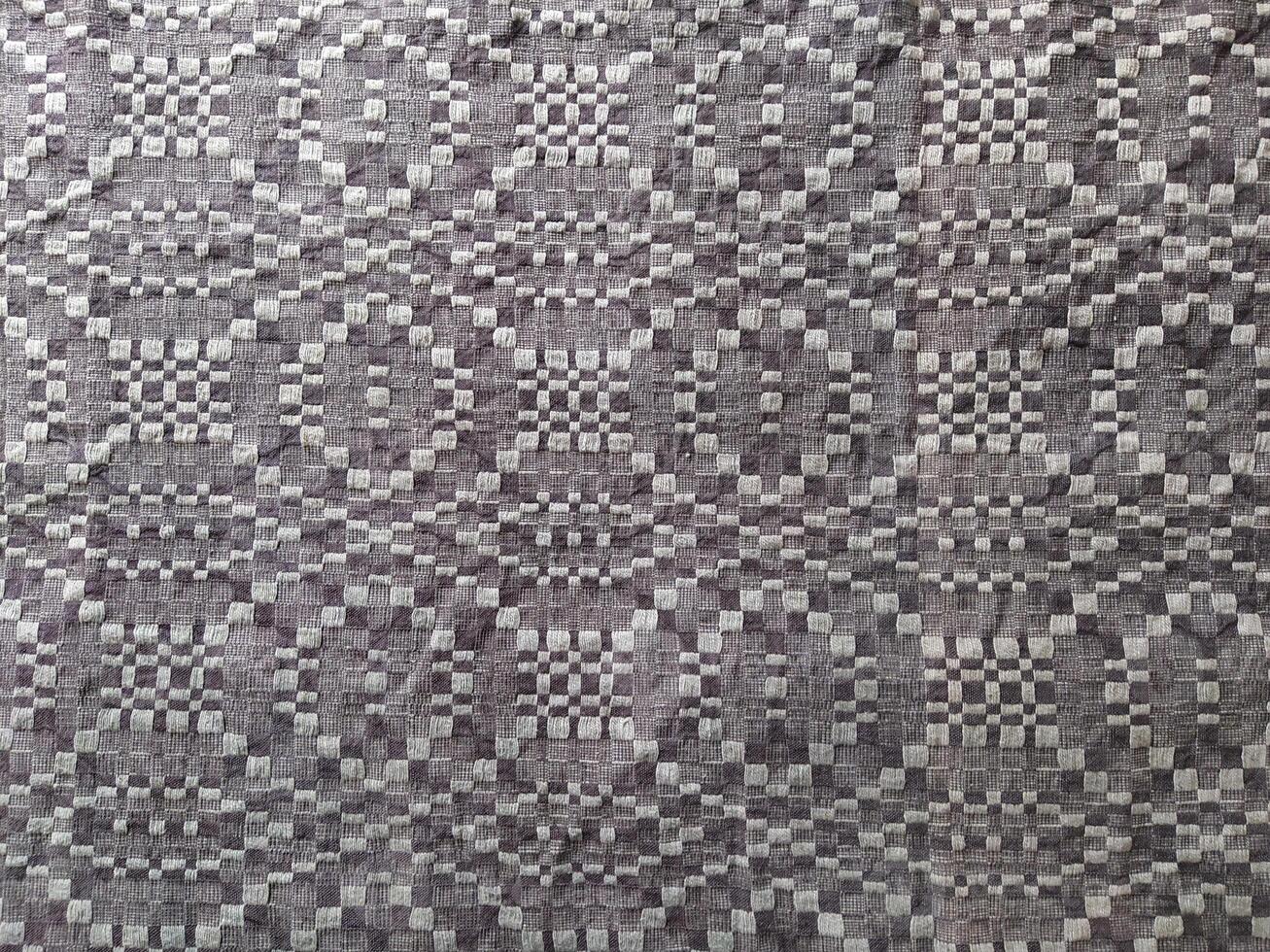 Handmade homespun fabric in an old rustic ethnic style. Traditional warm handmade texture effect. photo