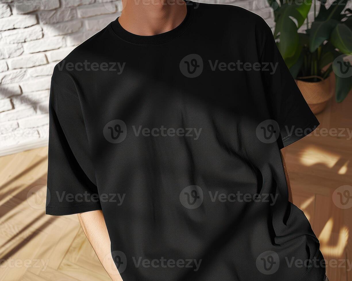 the young man is wearing a t - shirt while standing in front of a brick wall, photo
