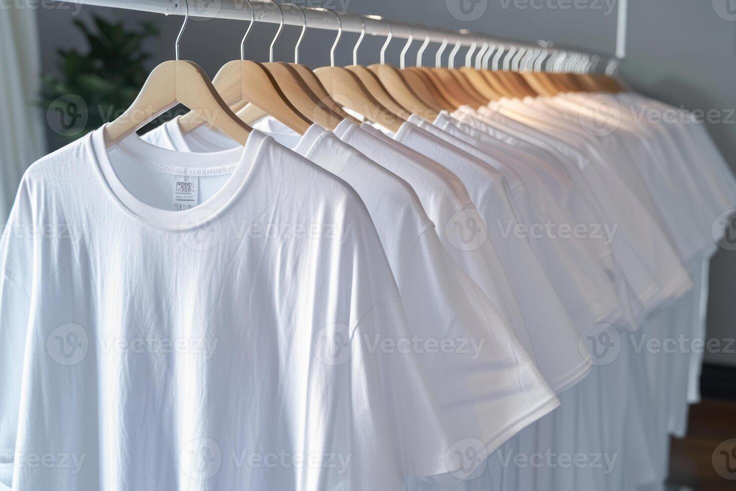 there are five white shirts hanging on a rack, photo