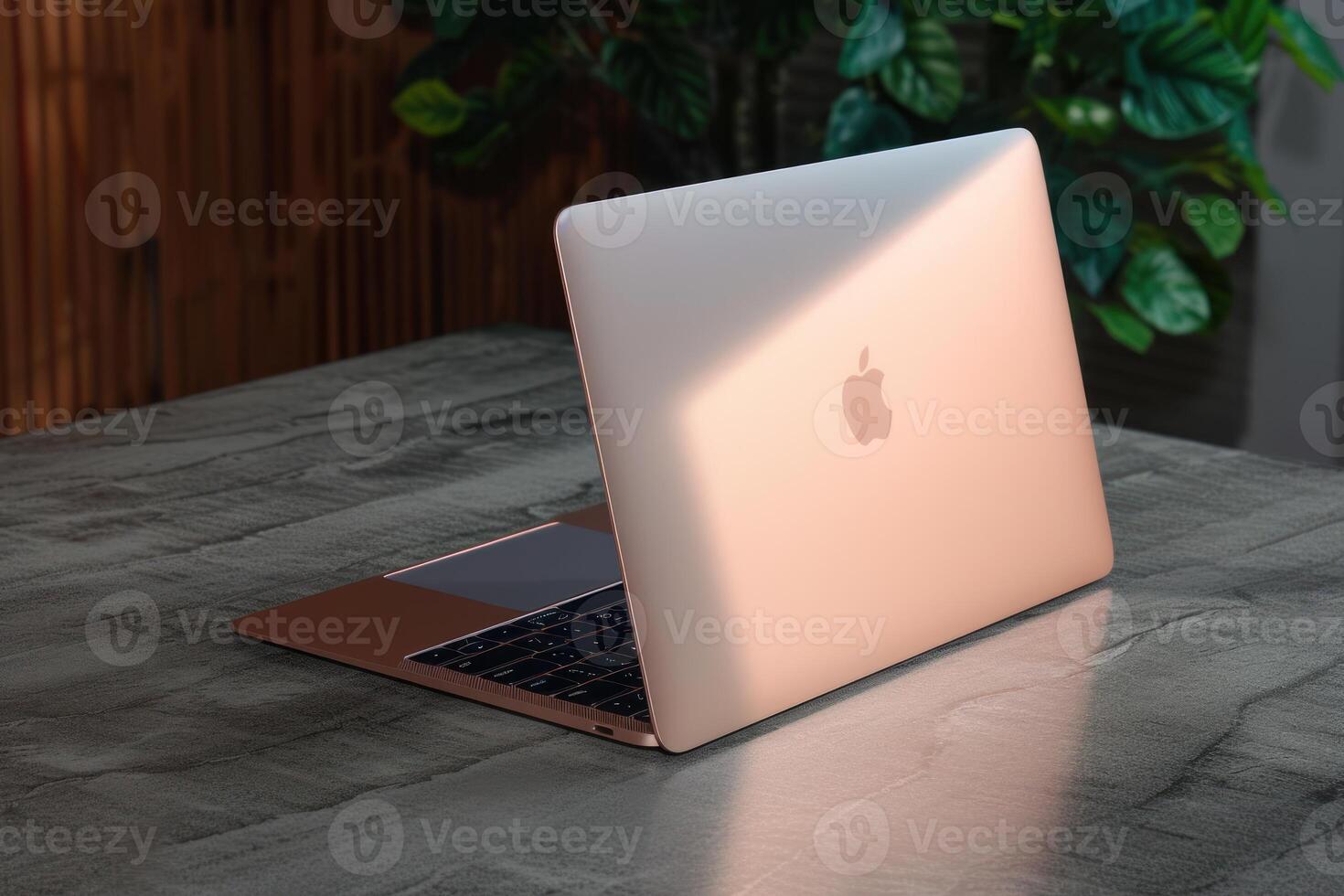 an apple laptop is on the table in light, photo