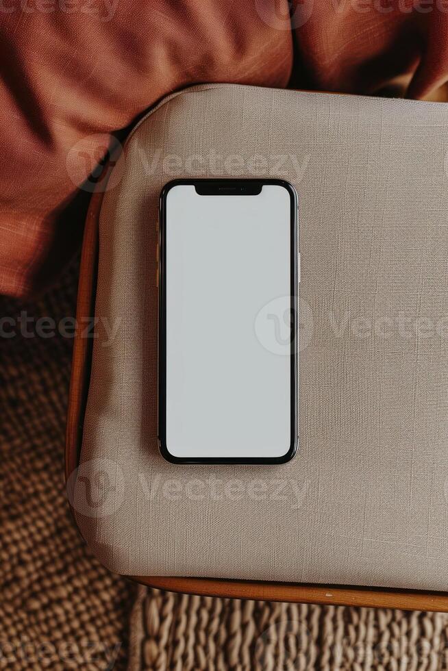 an empty cell phone on couch with pillow, photo