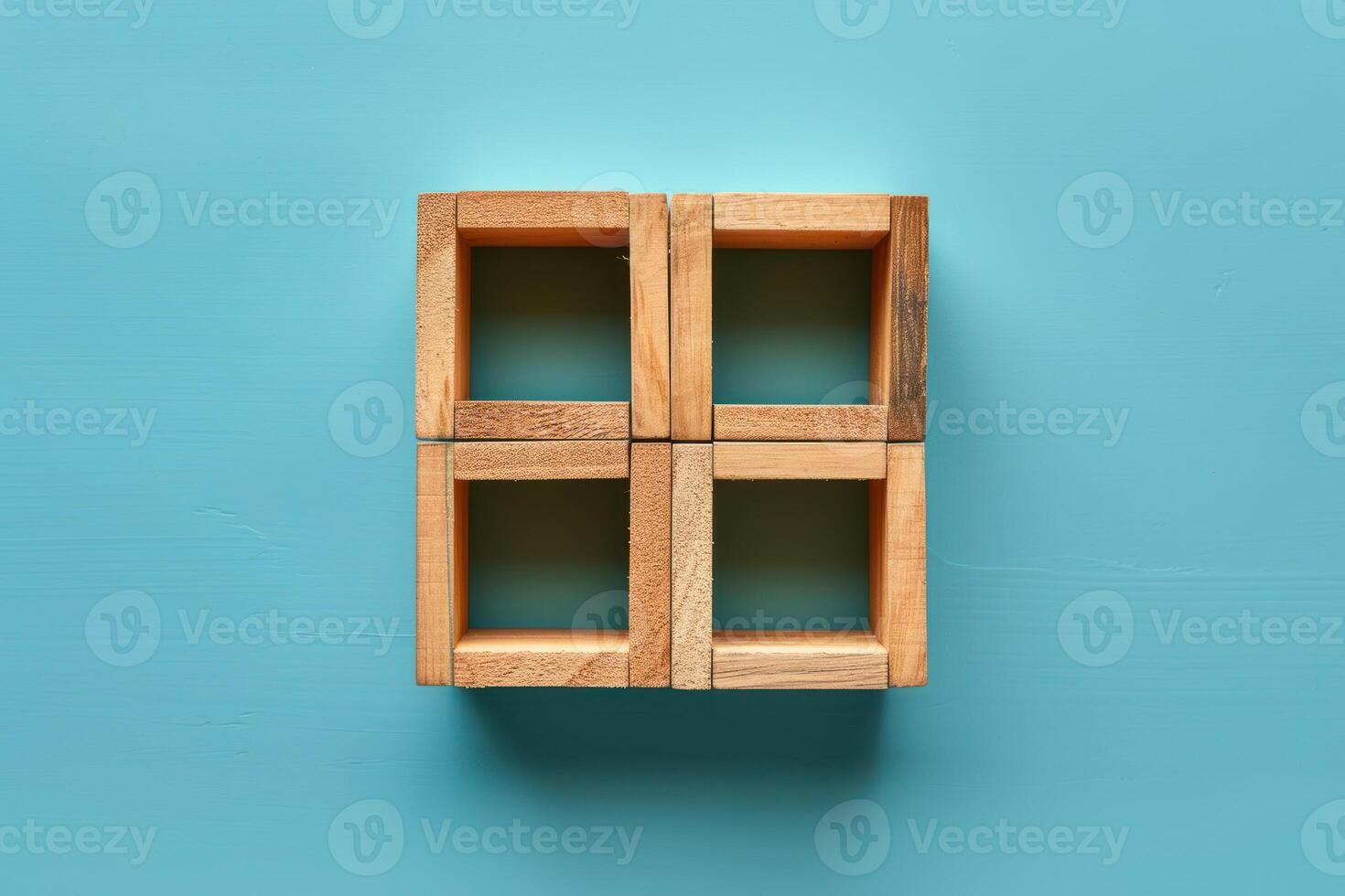 four wooden cubes arranged in a square arrangement on a blue background, photo