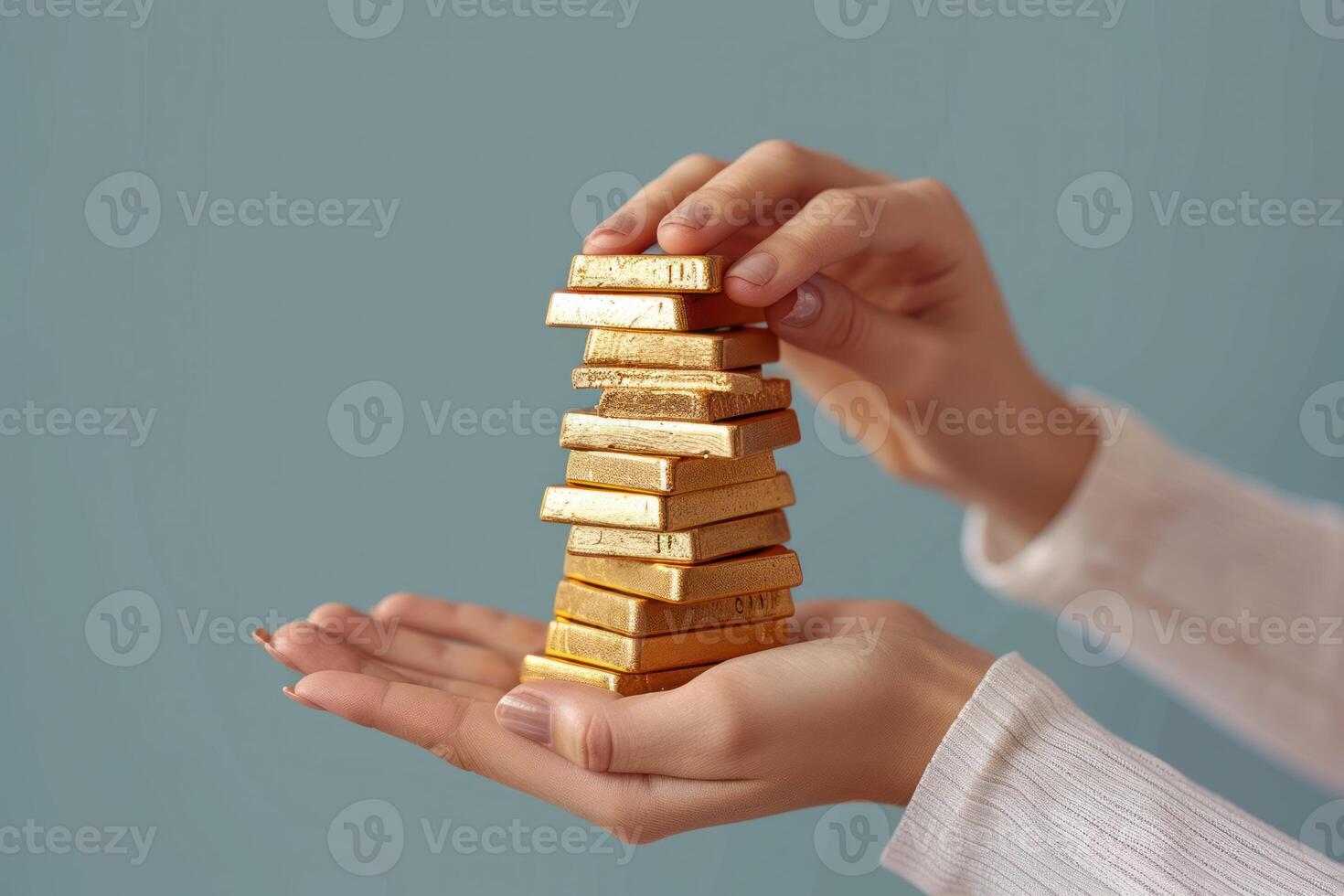 holding gold bars in her hand on a blue background, photo