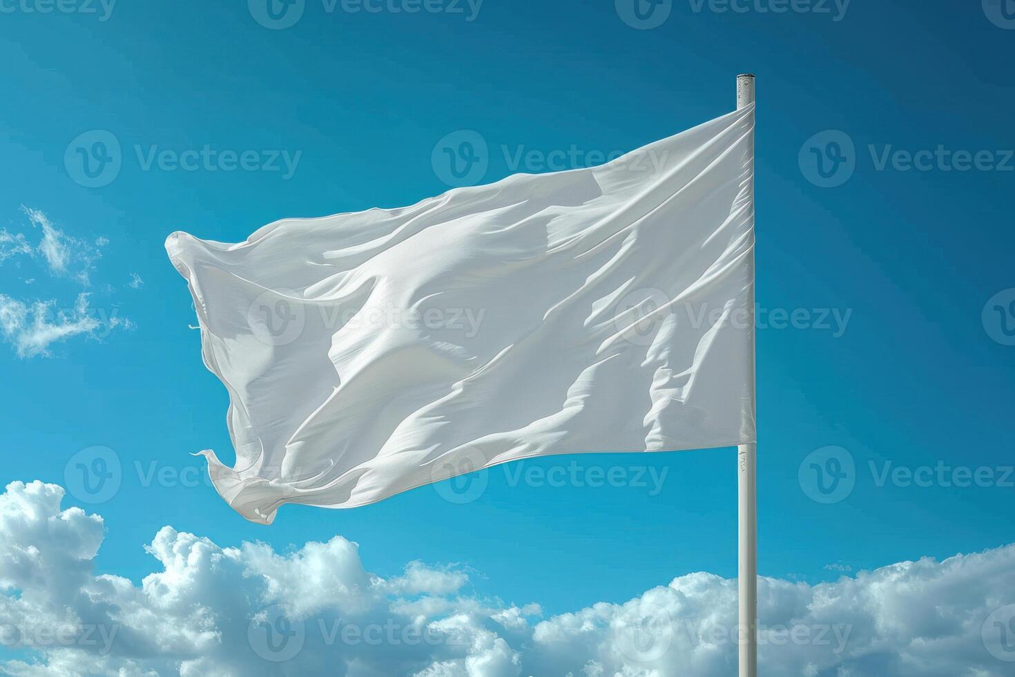 white flag waving in the wind with clouds and blue sky behind it, photo
