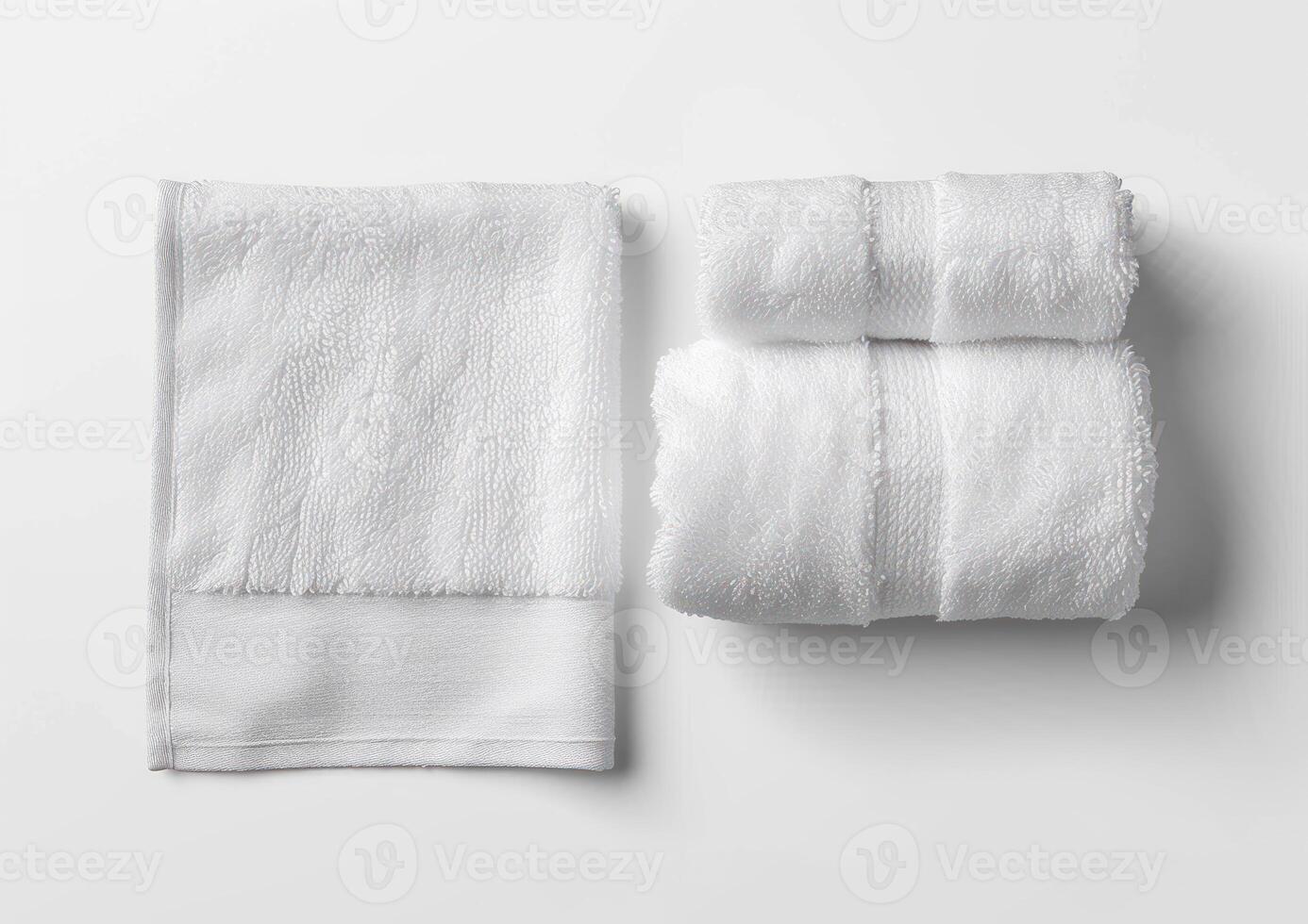 several white folded towels on top of a white surface, photo