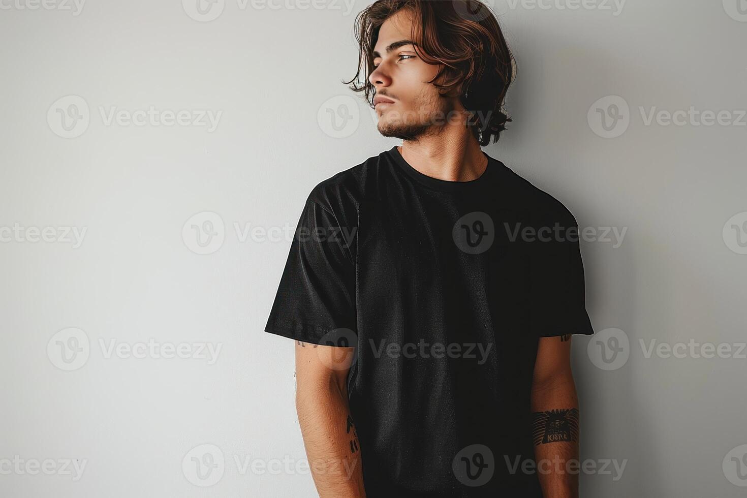 there is a man standing wearing a black t - shirt, photo