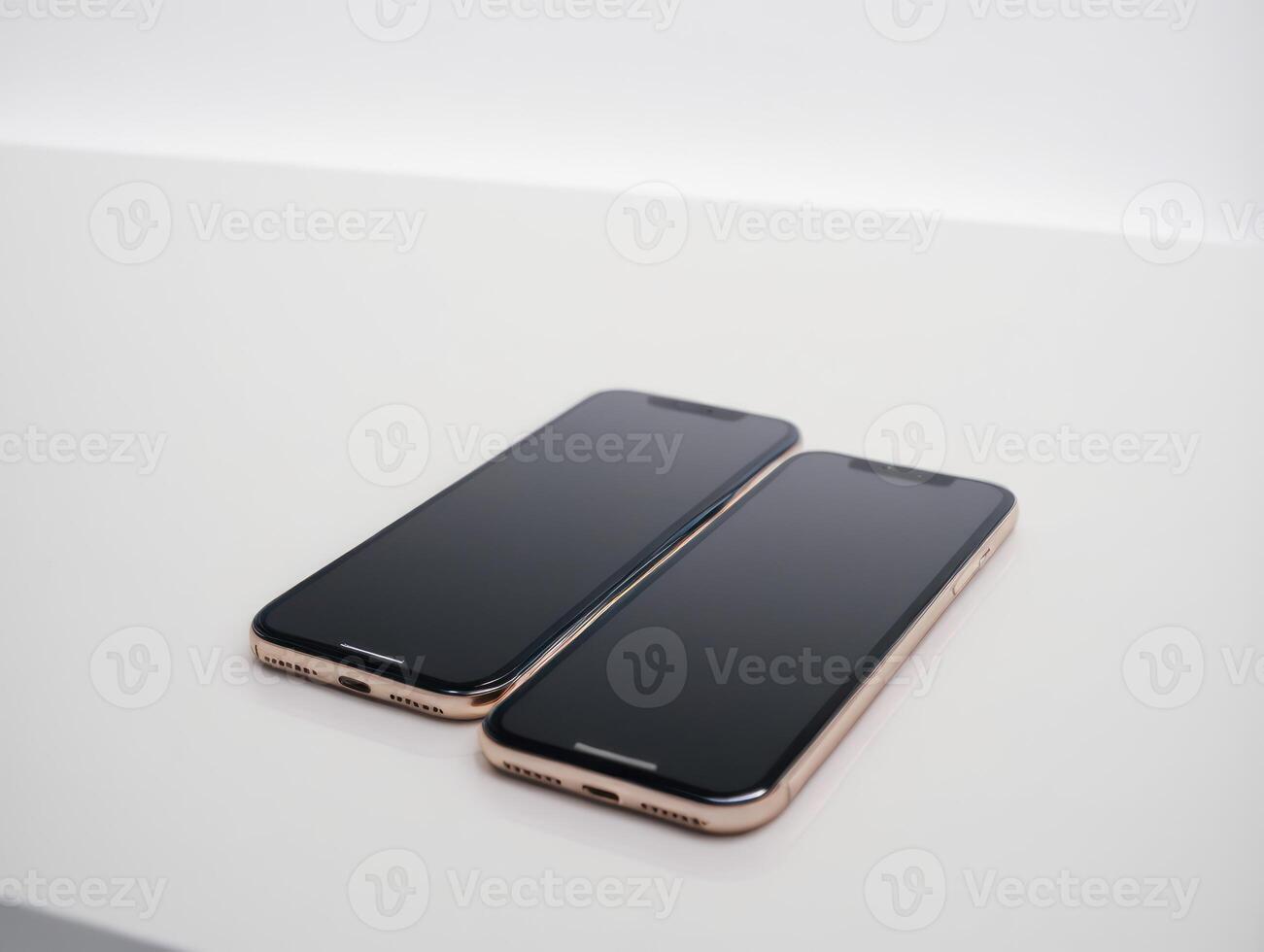 two iphones that are sitting on top of each other, photo