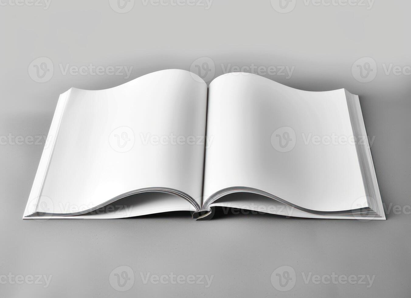 an open white book with pages curled forward on a table, photo