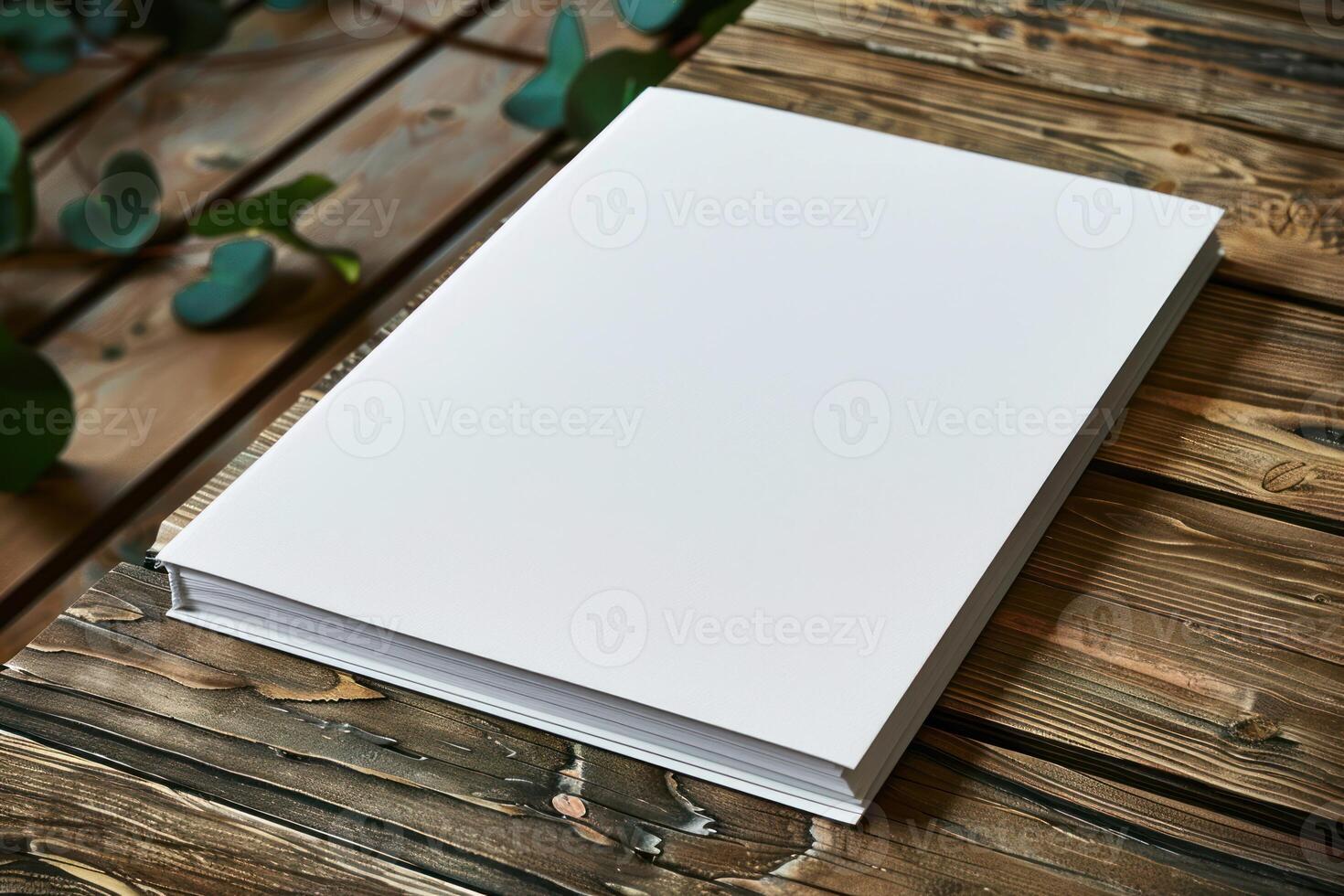 a blank paper is laying on top of an open notebook, photo