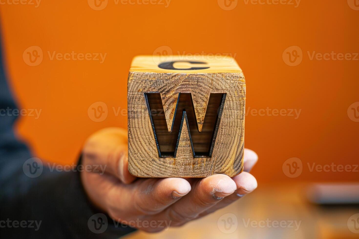 someone is holding a wooden block that says word with wood, photo