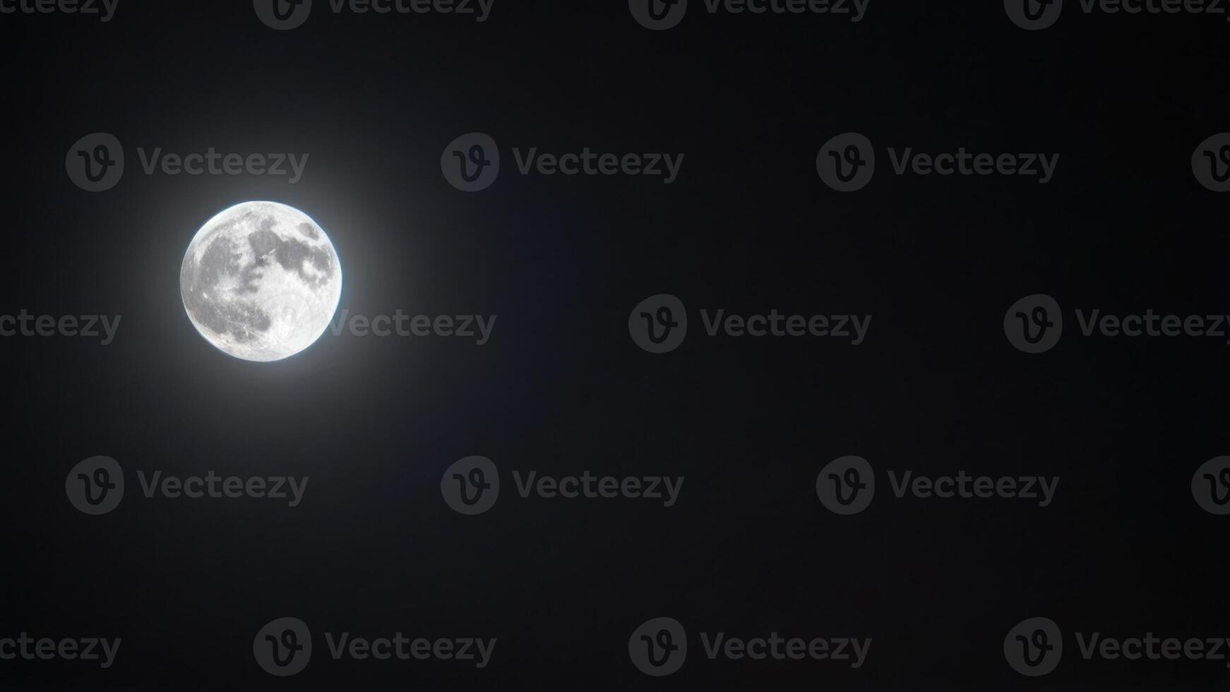 a full moon set on a cloudy night, photo