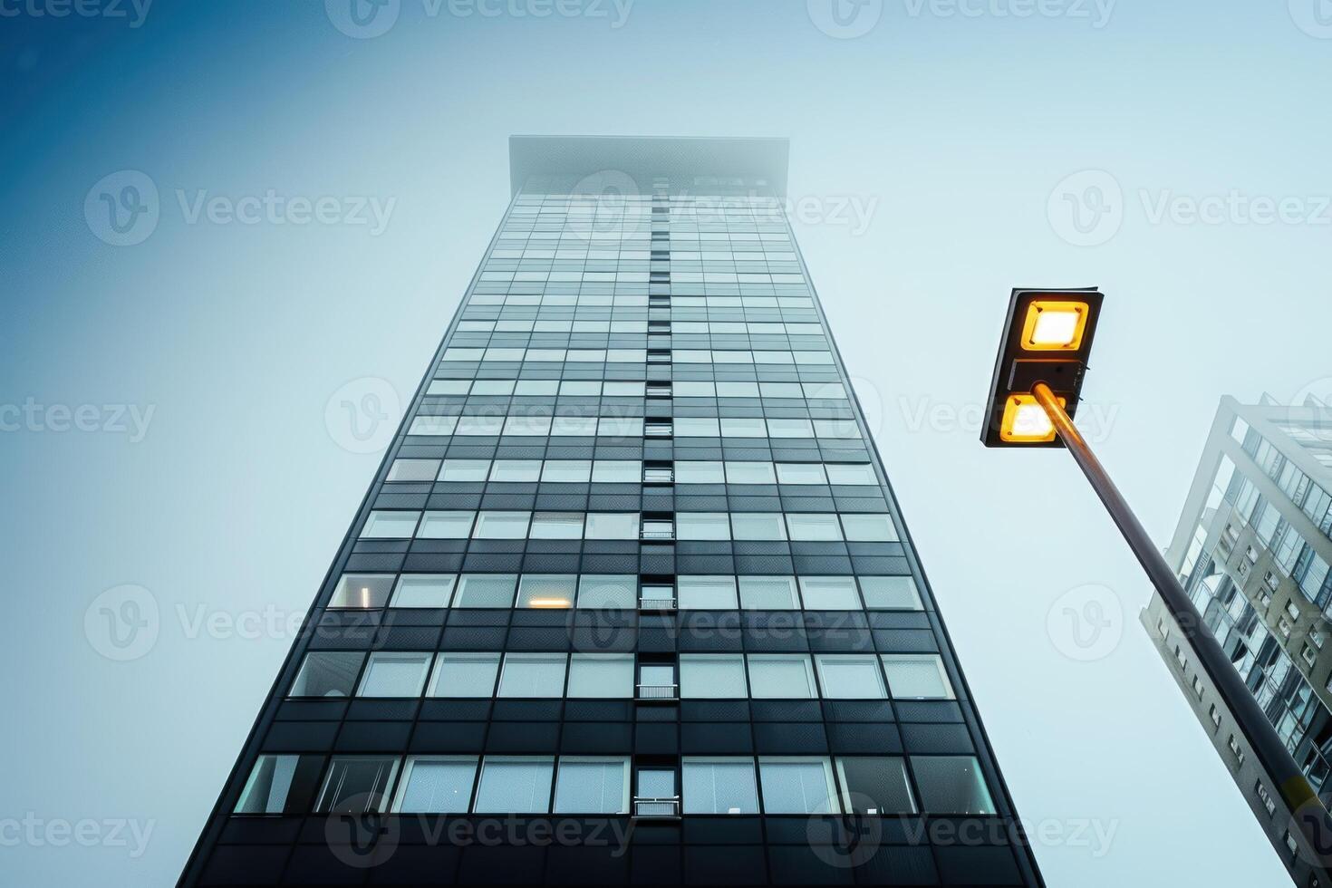 the streetlight is glowing near an illuminated tower, photo