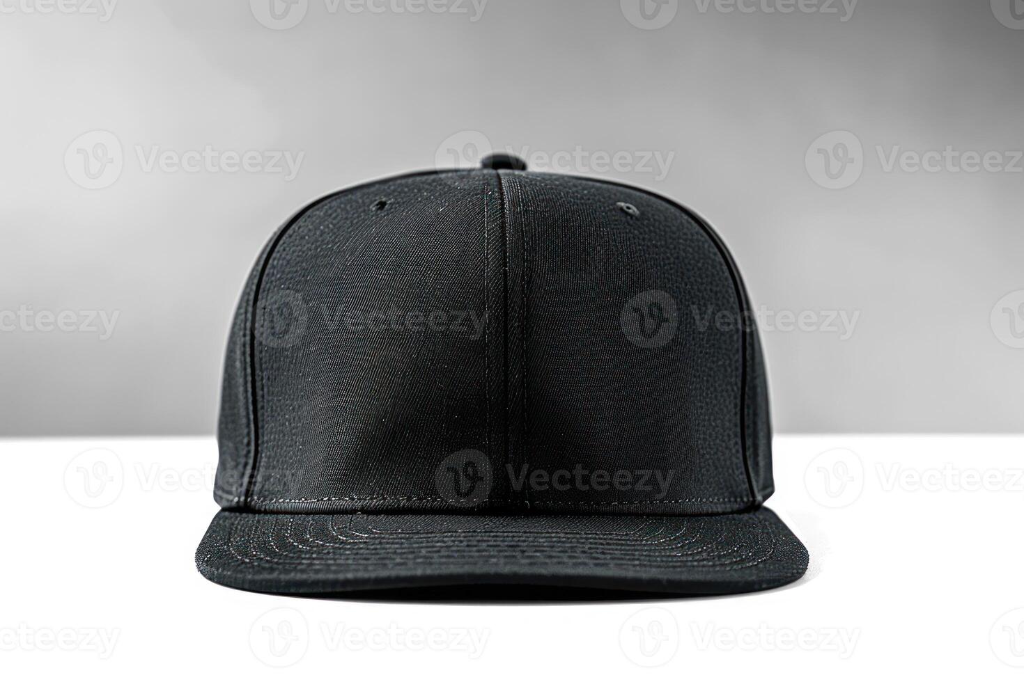 a black baseball hat on a white table, photo