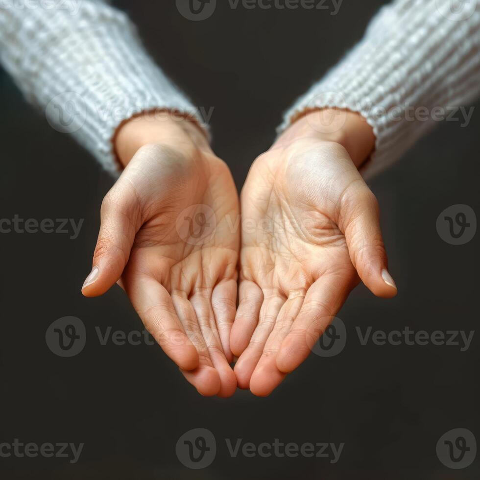 two large, open hands are holding each other, photo