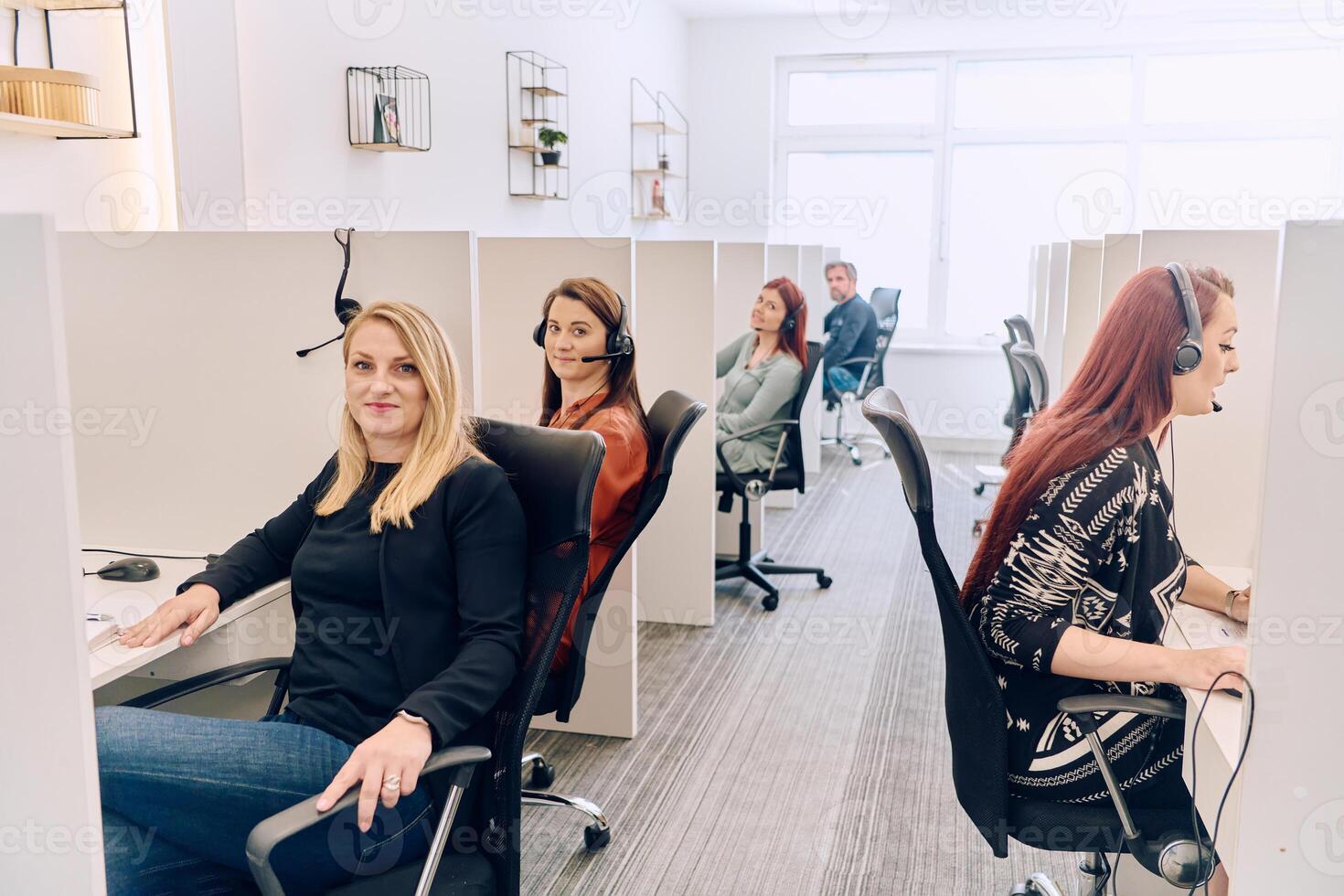 Team of Women Providing Customer Support in Call Center Environment. photo