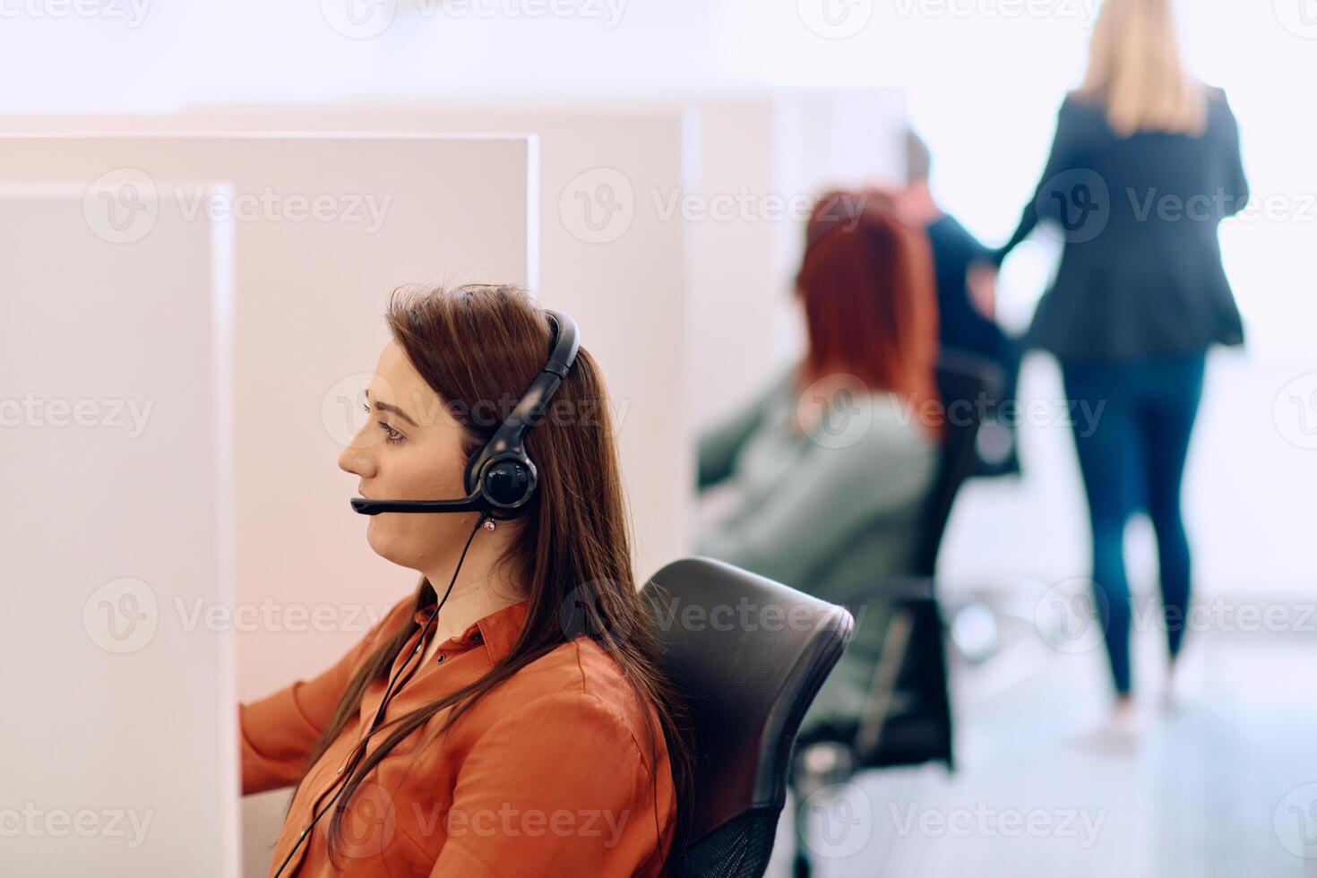 Team of Women Providing Customer Support in Call Center Environment. photo