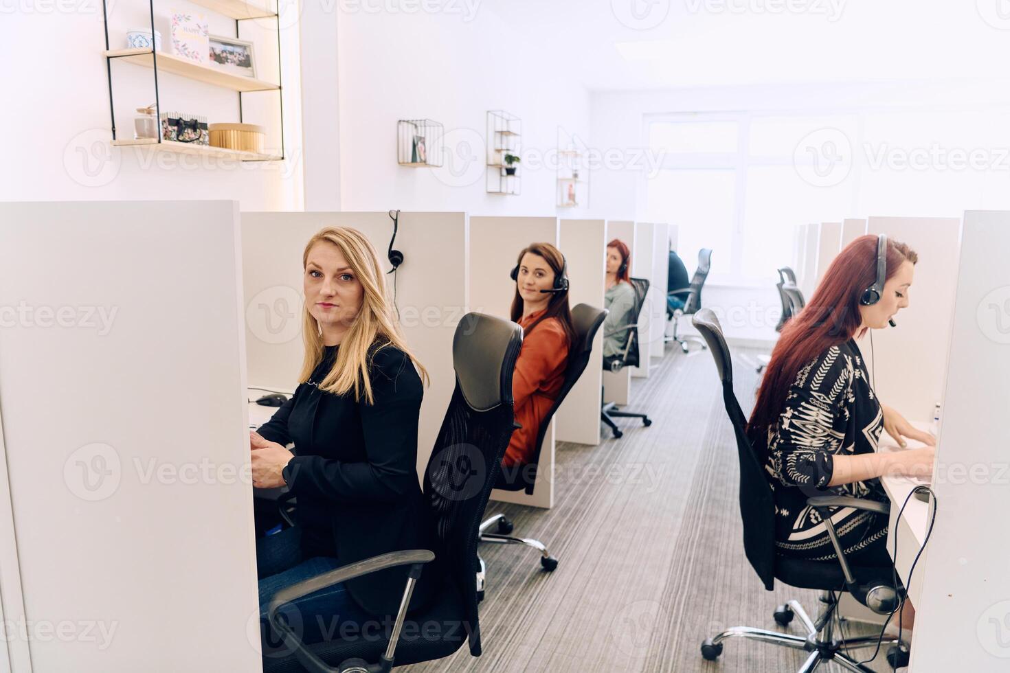 Team of Women Providing Customer Support in Call Center Environment. photo