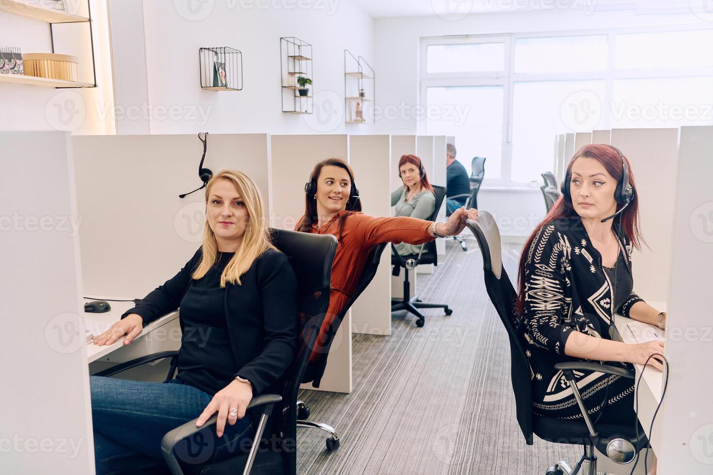 Team of Women Providing Customer Support in Call Center Environment. photo