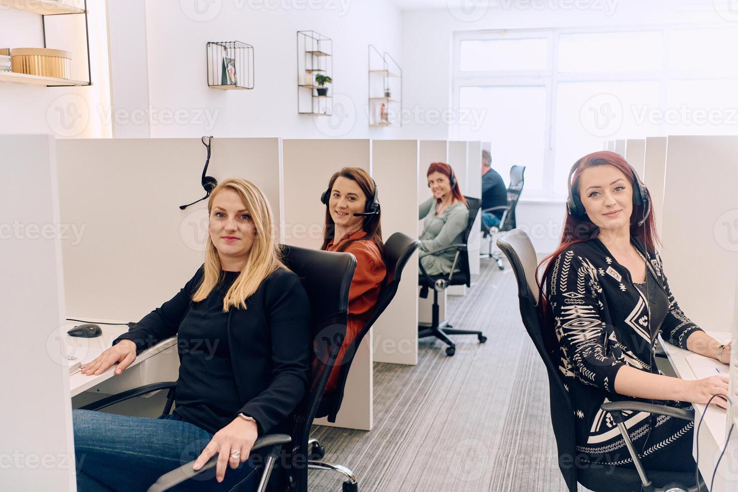 Team of Women Providing Customer Support in Call Center Environment. photo