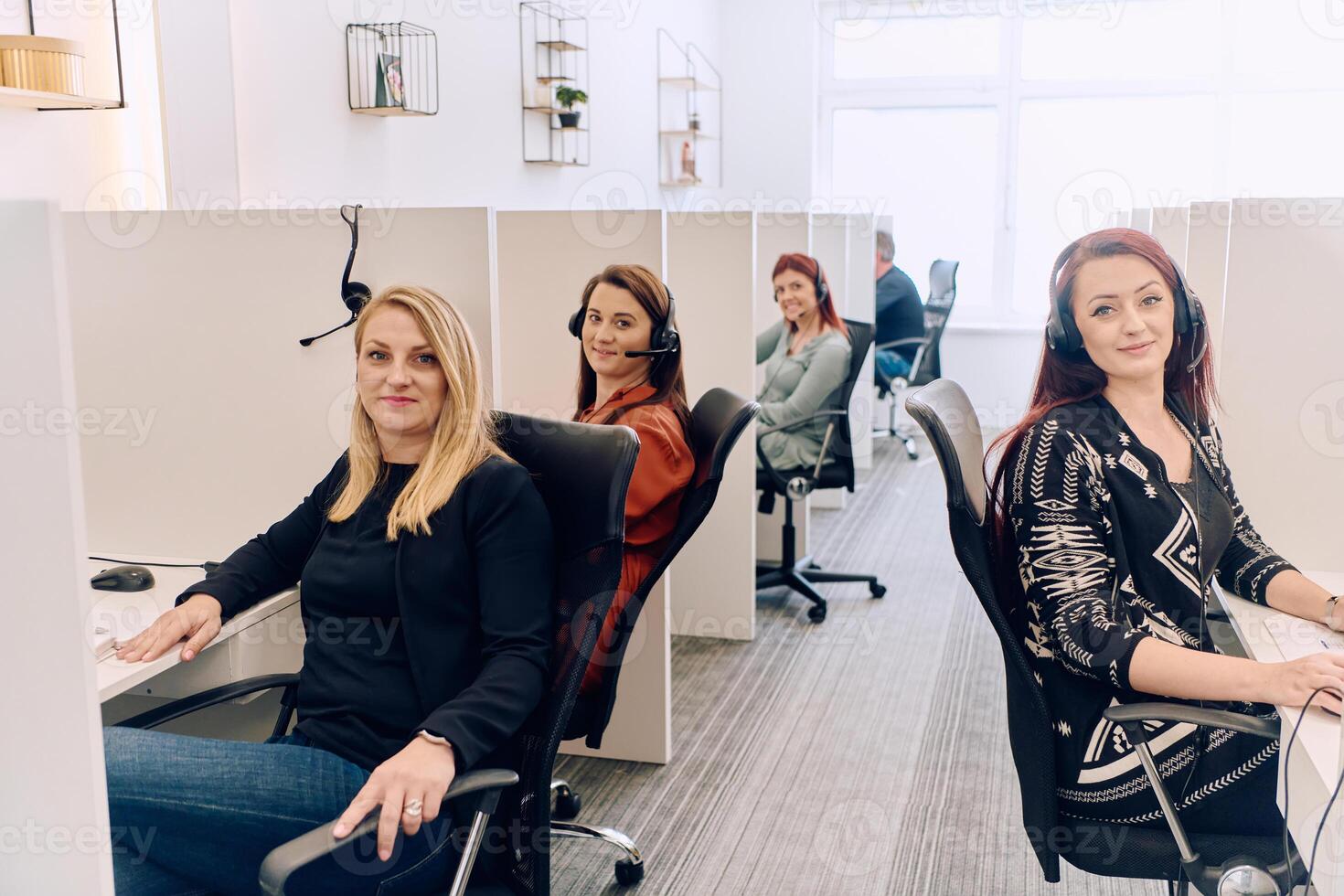 Team of Women Providing Customer Support in Call Center Environment. photo
