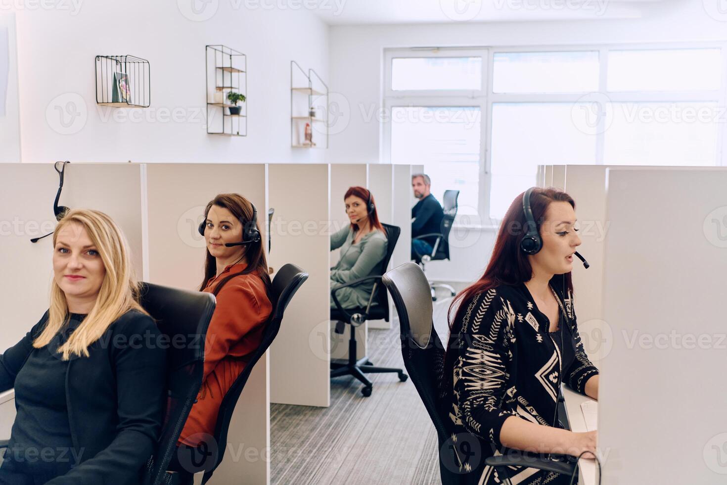 Team of Women Providing Customer Support in Call Center Environment. photo