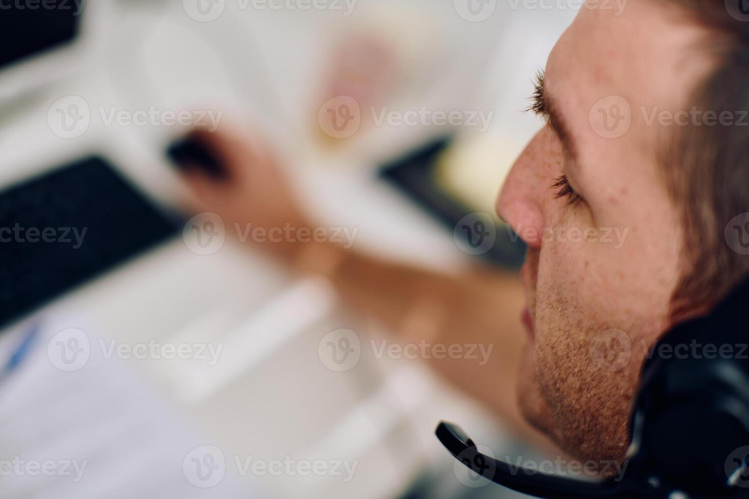 Close Up Portrait of a Customer Support Representative in a Call Center Environment. photo