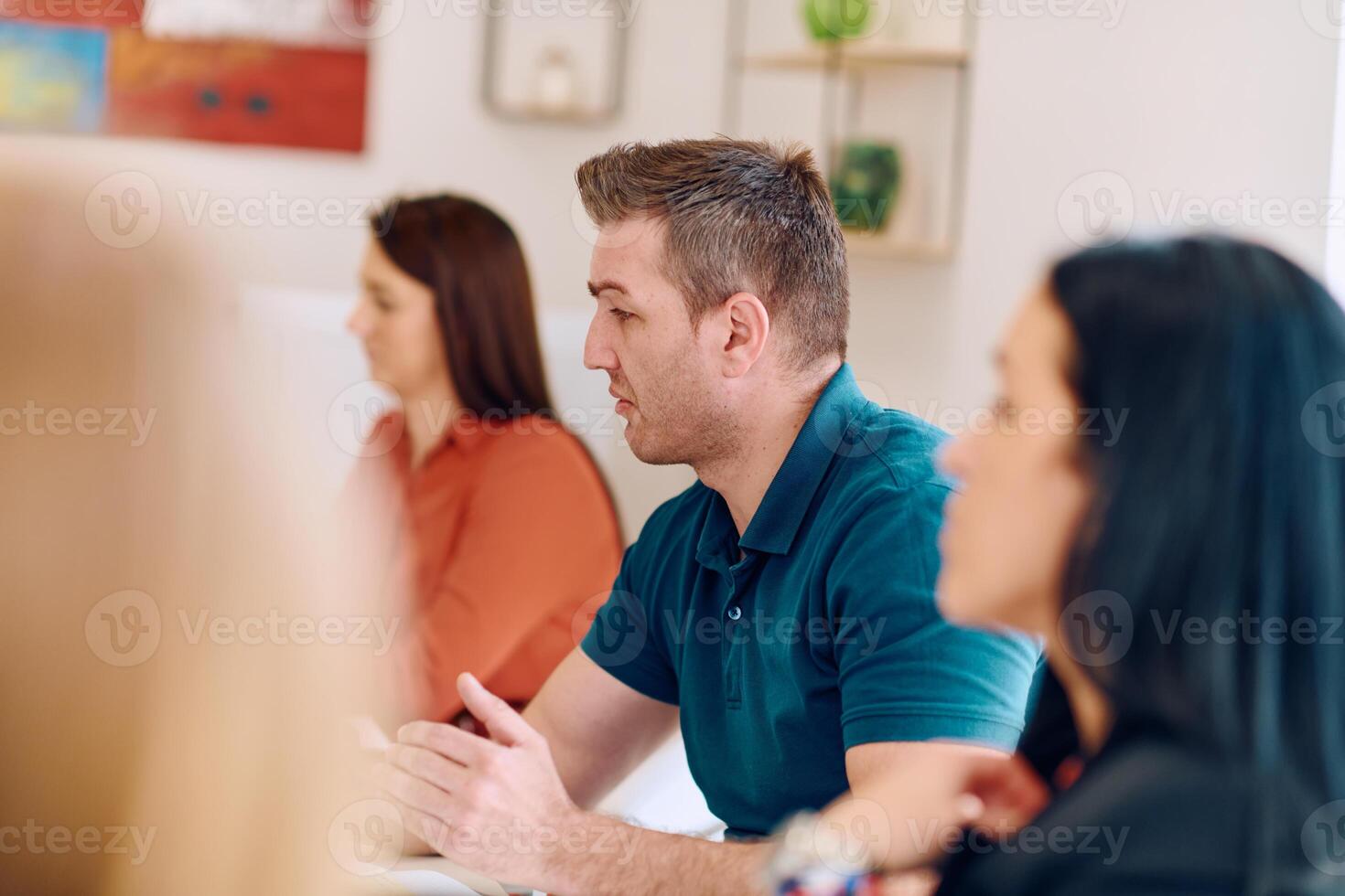 Diverse Business Team Discussing Projects in a Modern Glass Office. photo