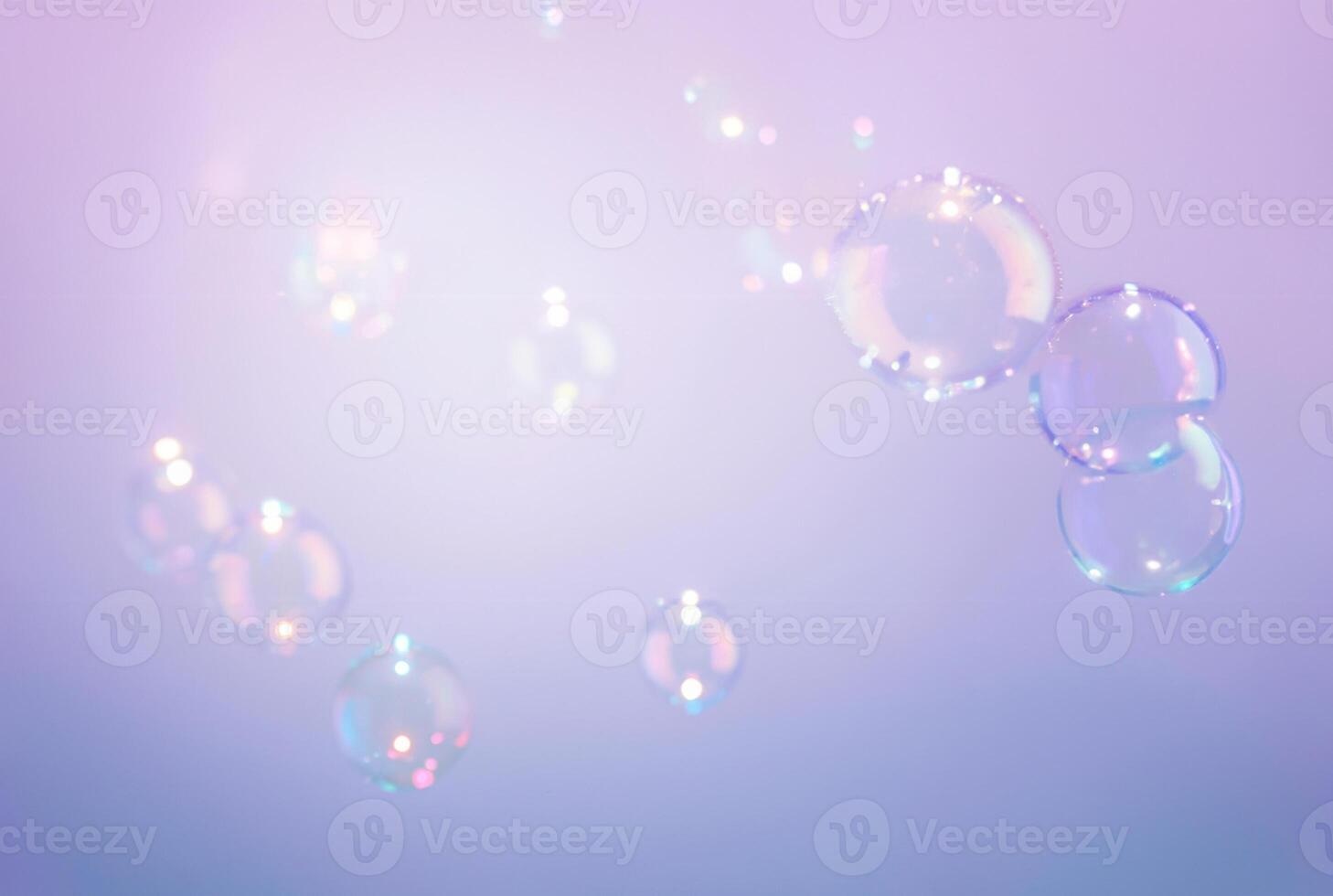 Transparent Soap Bubbles Floating on Purple Background photo