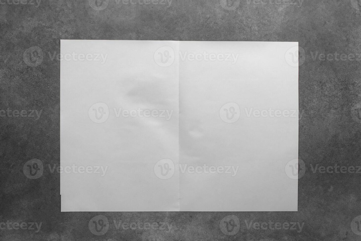 White Folded Paper on Concrete Wall photo