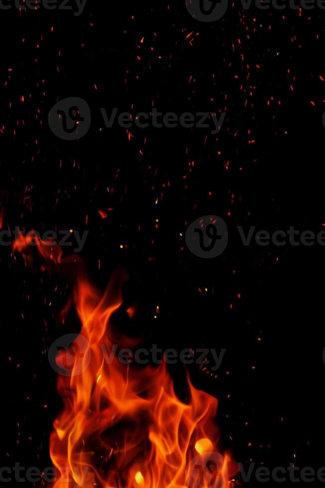 High-Resolution Image of Fiery Flames and Sparks on Black Background, Ideal for Barbecue or Culinary Themes photo