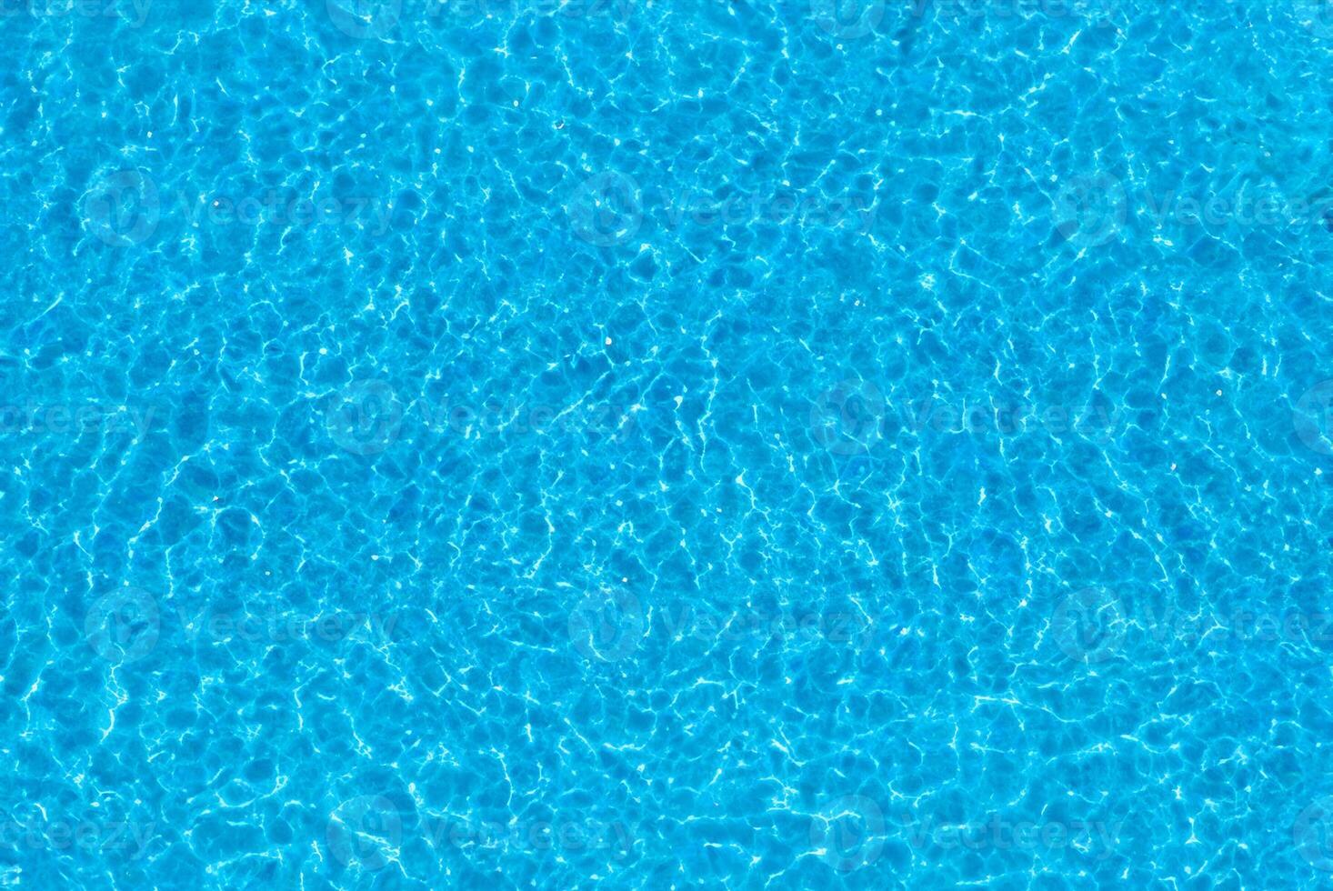 Top View of Rippling Water in Blue Tiled Swimming Pool photo