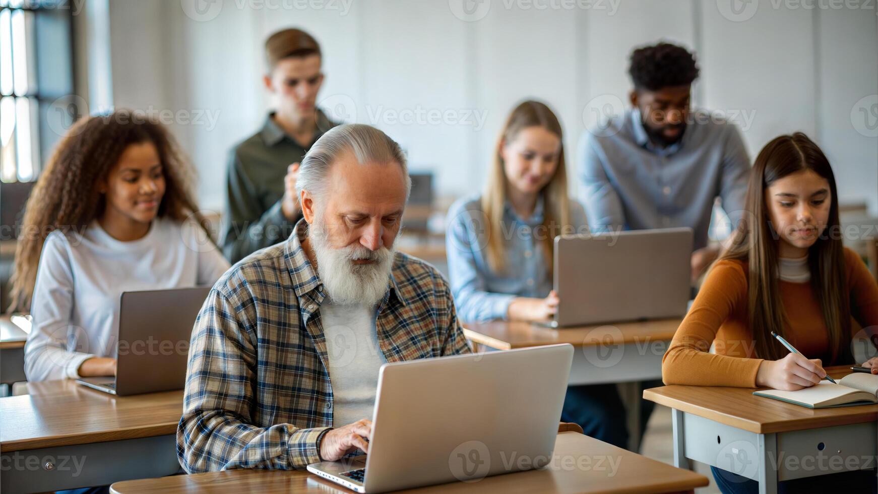 Group of multiethnic students using laptop in classroom. Selective focus. photo