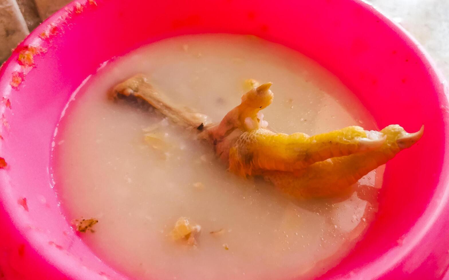 Corner meat meal with chicken feet legs in a bowl. photo
