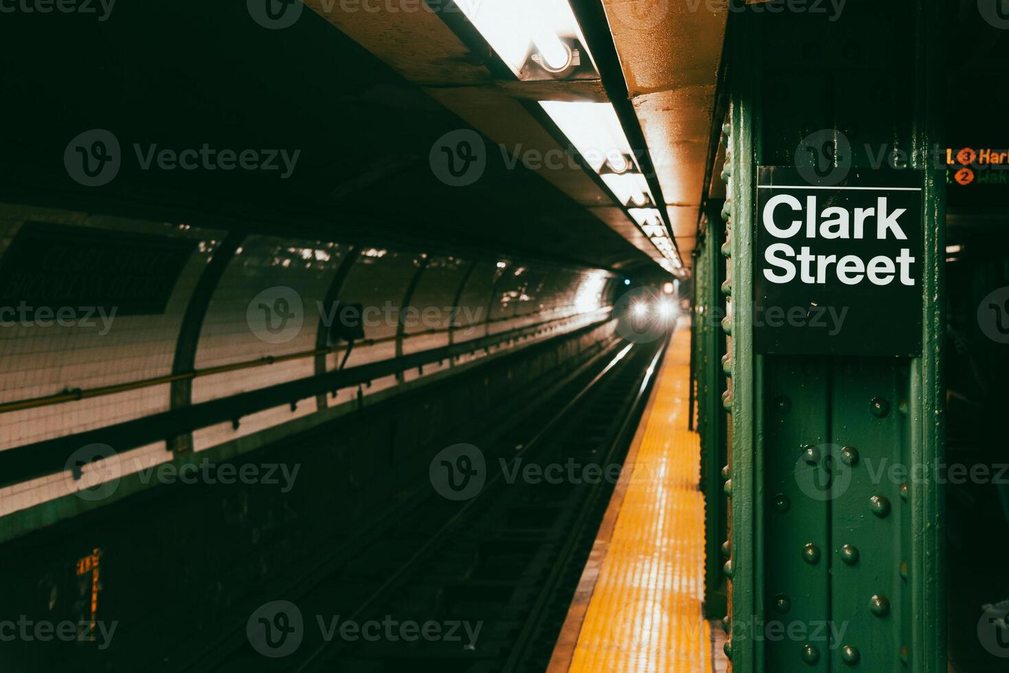 Train approaching clark street subway station in New York photo