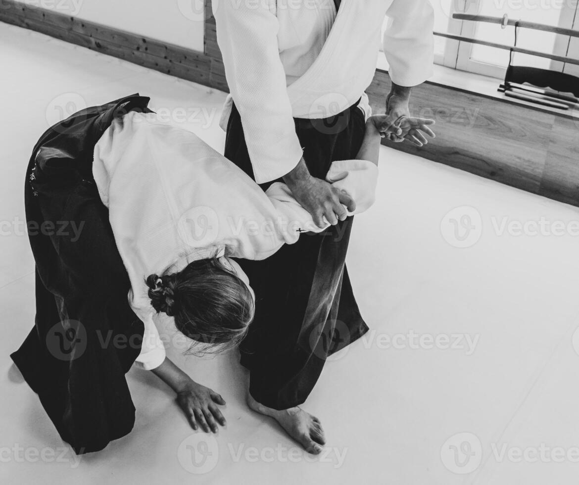 People practicing aikido in a dojo background. photo
