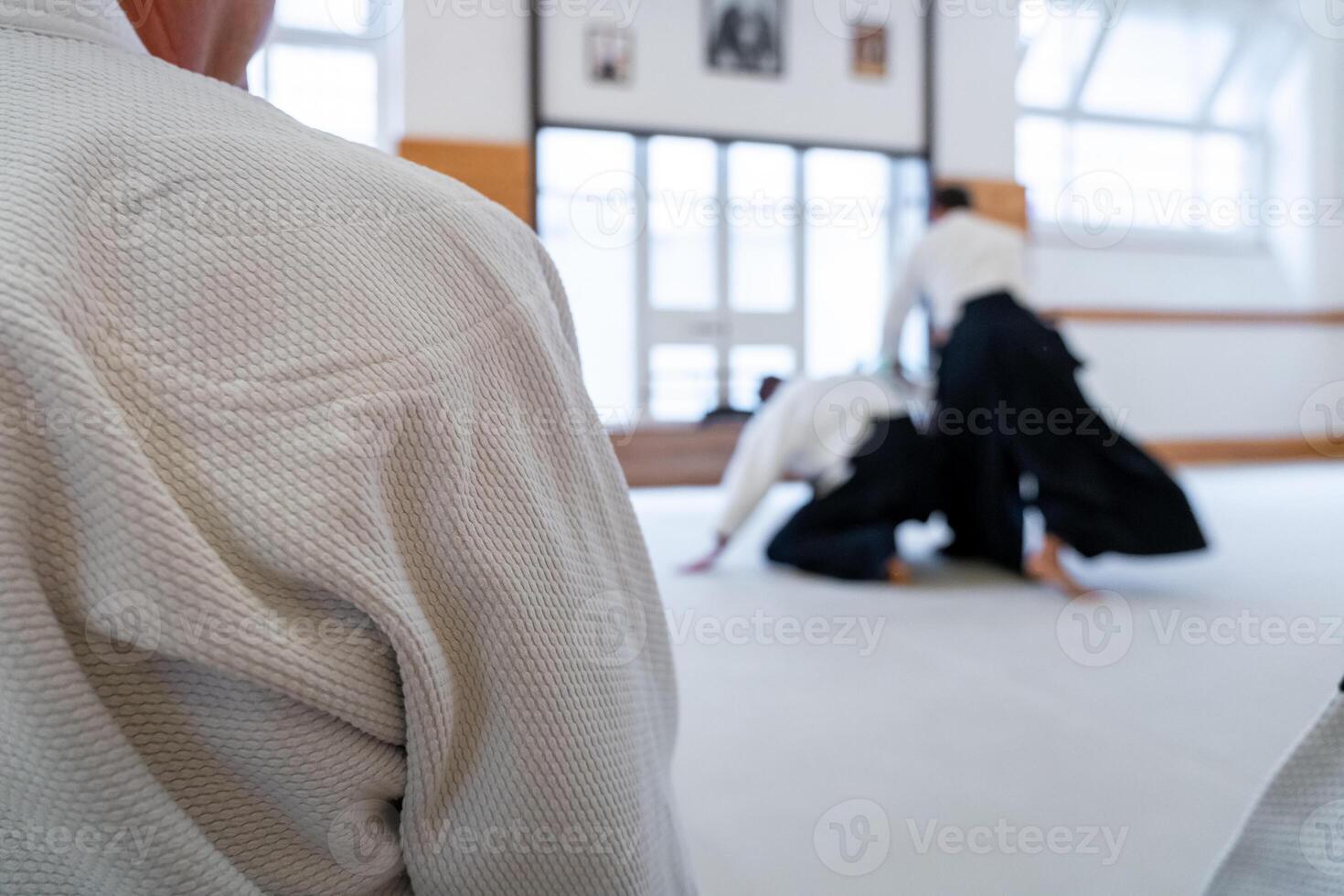 People practicing aikido in a dojo background. photo