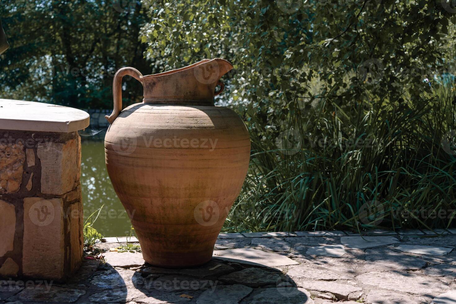A handcrafted clay jug embodying the timeless traditions of ceramics and the allure of handmade objects photo
